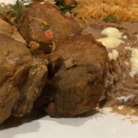 Carnitas Dinner · Seasoned pork chunks served with rice, refried beans, crema salad and tortillas.