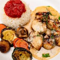 Chicken Oregano  · Pieces of chicken breast sauteed in lemon garlic sauce. Served with rice and grilled vegetab...