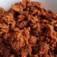 Quanta Firfir · Spicy. Dried strips of beef mixed with injera, house-made spiced butter, and ground chili po...