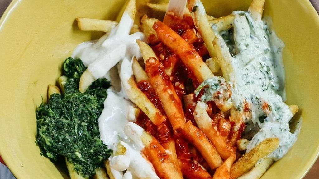 Feta Fries · curry dusted with garlic, herb, spicy green & red sauces