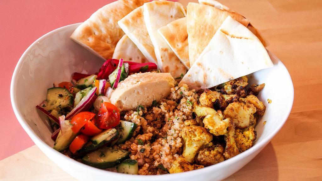 Veggie Bowl · cauliflower shawarma, warm pita, hummos, Persian salad, beet pickles atop quinoa tabouli. This is vegan and can be gluten free if you remove the pita!