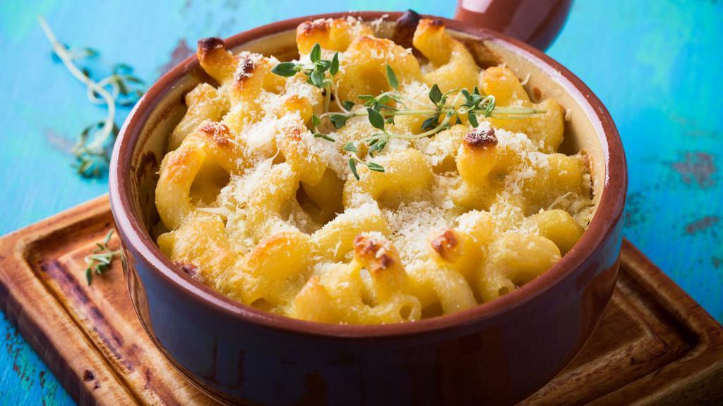 Mac N Cheese · Our famous mac n cheese made with our house cheese sauce.