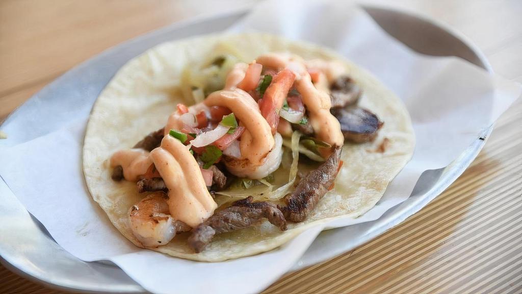 Surf & Turf · Seared shrimp, tri tip steak, blistered onions/poblanos, tomato pico, and chipotle queso. (549)