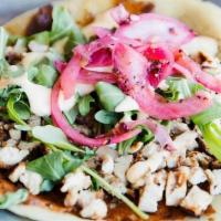 The G.O.A.T. Taco · Melted chihuahua cheese, grilled chicken, arugula, white BBQ sauce, and pickled red onions.