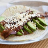 Bada Boom! · Spiced black bean puree, thick and crispy applewood smoked bacon, avocado wedges, queso fres...