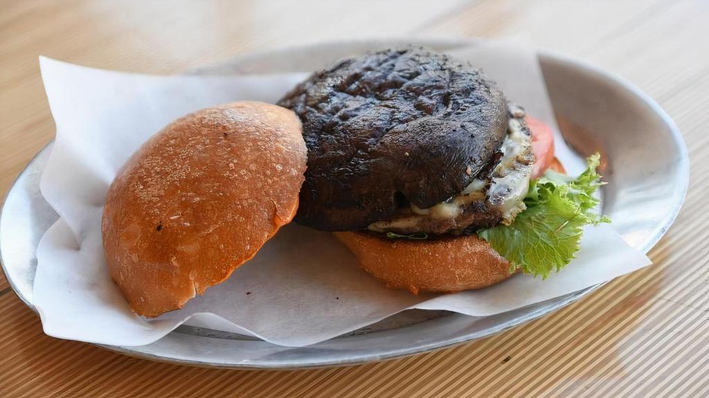 Porto Pure Burger · Creekstone Farms Premium Black Angus ground chuck and grilled portobello stacked together with crisp leaf lettuce, sliced tomato and UNspread on a toasted egg bun. (720)