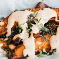 Not So Sweet Potato Wedge · Sweet potato wedges, roasted and fried to perfection, topped with harrisa sour cream, queso ...
