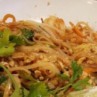 Pad Thai · Spicy. Thin rice noodles stir fried with peanuts, bean sprouts, carrots, onions, eggs & meat...