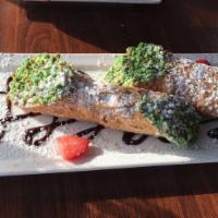 Cannoli · Cannoli shells, whipped chocolate chips, ricotta filling, nuts and powder sugar.