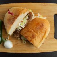 Torta · A Mexican style sandwich with your choice of meat, refried beans, lettuce, tomato, sour crea...
