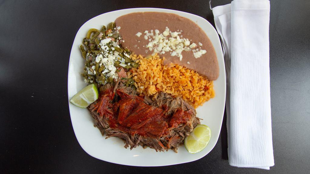 Barbacoa De Res Dinner · Steamed beef cooked to perfection marinated our secret adobo sauce. Served with a cactus salad, rice, and refried beans.