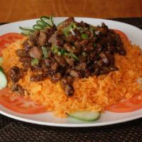 Beef Cube Over Tomato Rice · Tender flank steak with specialty sauce on top a bed of rice lightly sweetened with tomato a...