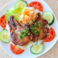 Pork Chop Rice · A pair of tender pork cutlets, marinated and grilled for a rich, smoky flavor, on top a bed ...