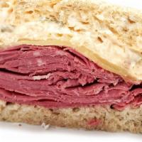 Corned Beef Reuben · Corned beef, swiss cheese, Russian dressing, and a choice of sauerkraut or coleslaw on rye b...