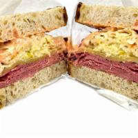 Conflicted Reuben · Corned beef and pastrami, with swiss cheese, Russian dressing, and the choice of sauerkraut ...