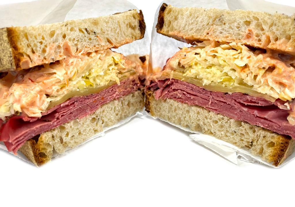 Conflicted Reuben · Corned beef and pastrami, with swiss cheese, Russian dressing, and the choice of sauerkraut or coleslaw on rye bread.