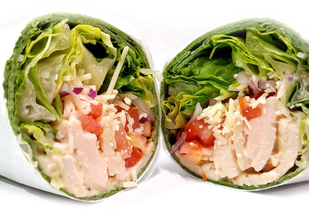 Chicken Caesar Wrap · Roasted chicken, parmesan cheese, romaine lettuce, tomato, onion, and caesar dressing wrapped in a spinach and herb wrap.