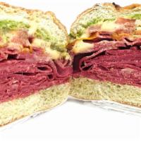 Corned Beef & Pesto · Corned beef, cheddar, tomato, pesto, and spicy mayo on an onion roll.