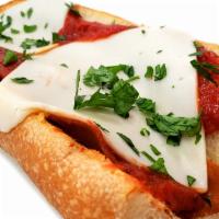 Vegan Pizza Sub · Pizza sauce, vegan mozzarella, vegan pepperoni, vegan capicola, and Italian parsley on a hoa...