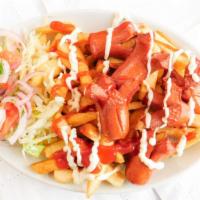 Salchipapas · Potato fries served with sausage, mayonnaise and ketchup and salad.