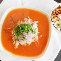 Encebollado · Tuna fish soup with cassava, red onion, with toasted corn, plantain chips and popcorn or rice.