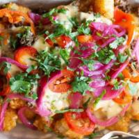 Loaded Tots · Ground beef, pickled red jalapeño, fancy queso, pickled red onions, and cilantro.