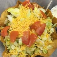 Taco Salad · Fried tortilla bowl, taco meat, lettuce, cheese and tomatoes.