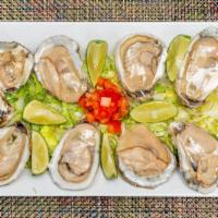 Ostiones En Su Concha · Oyster with shrimp octopus cucumber tomato and onion.