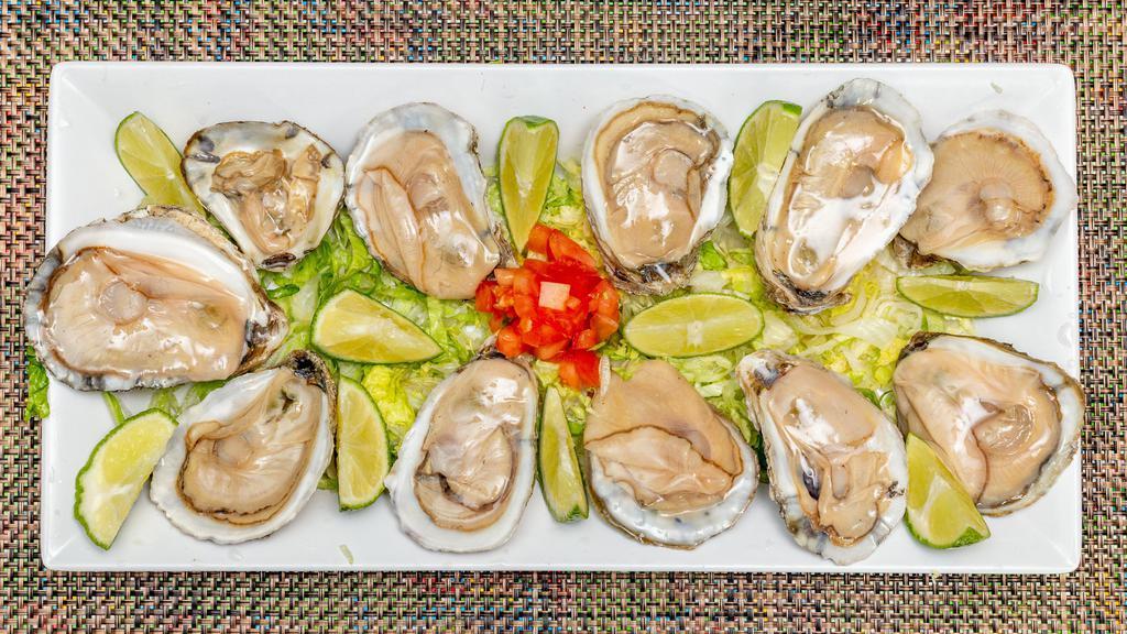 Ostiones En Su Concha · Oyster with shrimp octopus cucumber tomato and onion.
