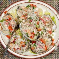 Ostiones Especiales · Oyster with shrimp octopus cucumber tomato and onion.