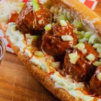 The Spicy Buffalo Meatball · Pop's meatballs topped with buffalo sauce and ranch dressing .