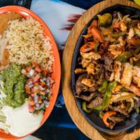 Fajitas Jalisco · Steak, chicken and shrimp, grilled onions, bell peppers and tomatoes. Served with rice, bean...