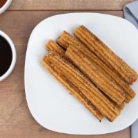 Churros · 6 warm churros with caramel and chocolate dipping sauces.