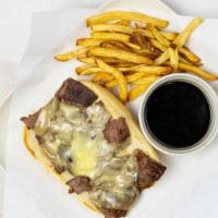 Pub Dip · Sliced ribeye with melted swiss cheese and au jus on a toasted hoagie roll.
