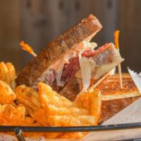 Reuben · Corned beef, Swiss cheese, sauerkraut and Thousand Island dressing served with a side of fri...