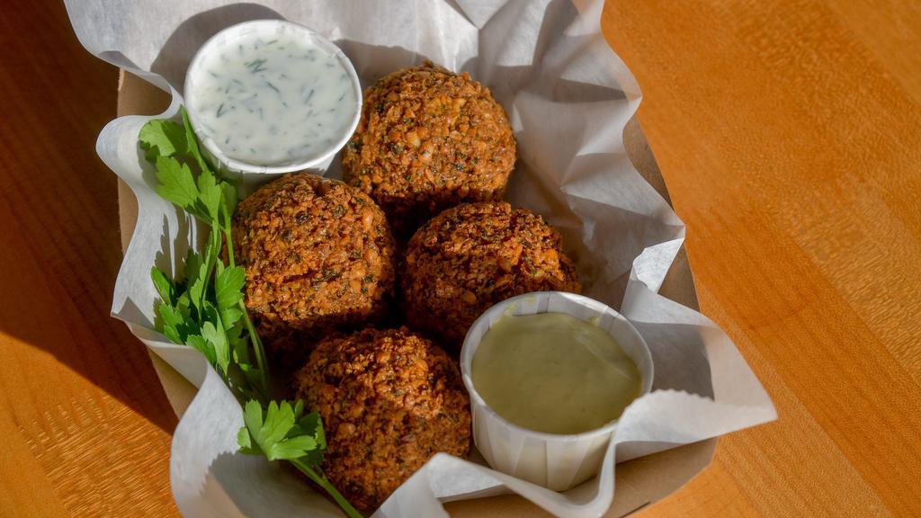 Falafel · Vegetarian. Four pieces to order served with side of curried yogurt and hot chimichurri