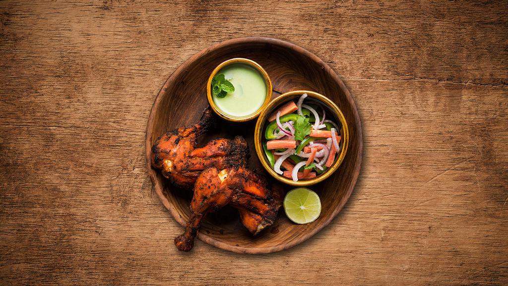 Charred Tandoori Chicken · Chicken marinated overnight in a prepared mix of yogurt, spices, herbs, and cooked in a clay oven.