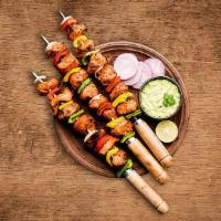 Charred Chicken Tikka · Boneless chunks of chicken marinated in Yogurt, Mace, Ginger And Other Spices in a clay oven...