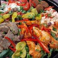  15. Combination Platter · Includes chicken, gyros, falafel, hummus, Greek salad, garlic dip, and pita.