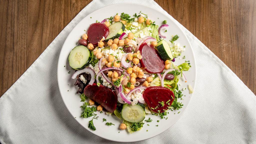 Greek · Vegetarian, gluten free. Mixed greens, Feta, tomatoes, red onion, beets, garbanzo beans, kalamata olives, cucumbers, pepperoncinis. Tossed with house vinaigrette or creamy Greek dressing.