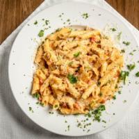 Cajun Chicken Pasta · Penne pasta tossed with diced breast of chicken, tomatoes and green onions in a Cajun-season...