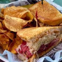 Traditional Reuben · Hot corned beef, swiss cheese, sauerkraut, and Russian dressing, on grilled rye.