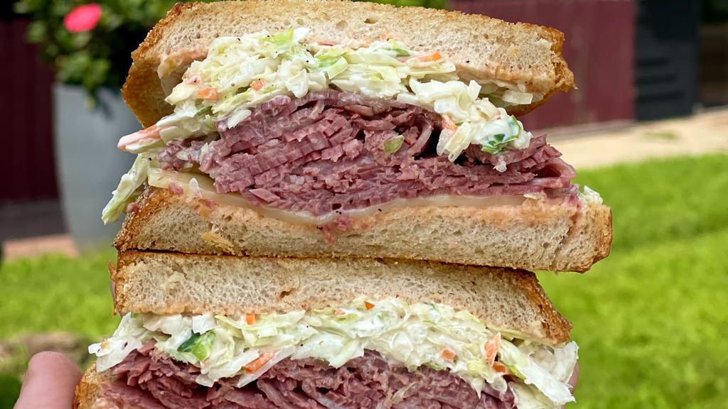 New Yorker · Corned beef, swiss cheese, coleslaw, Russian dressing on grilled rye.