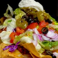 Macho Nacho · Freshly fried tortilla chips, beef chili, mixed cheeses, tomatoes, lettuce, red onions, jala...