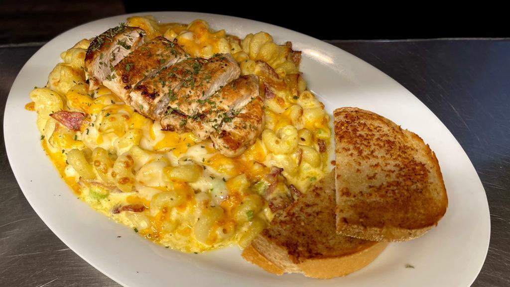 Ultimate Mac And Cheddar · Our cheddar cheese sauce, cavatappi pasta, bacon, scallions, topped with a grilled chicken breast, more cheese, seasoned bread crumbs, and baked until bubbly. Served with garlic rye toast.