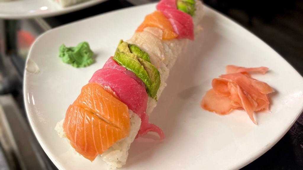 Rainbow · Crab mix, avocado, and cucumber rolled and topped with salmon, yellowtail, tuna, and avocado.