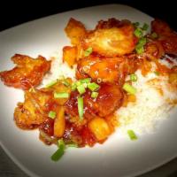 Sweet And Sour Chicken · Tempura chicken served with peppers, onions, and pineapple in a sweet and sour sauce over ri...