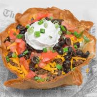 Taco Salad · Lettuce, tomato, green onions, black olives, cheddar cheese, taco meat and sour cream in a t...