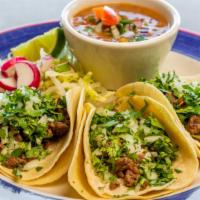 Mexican Taco Dinner · Three of your choice: carne asada, chicken, carnitas, pastor or chorizo, served with corn to...