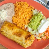 Burrito Dinner · Served with refried pinto  beans, rice Lettuce, sour cream, guacamole and tomatoes on the si...